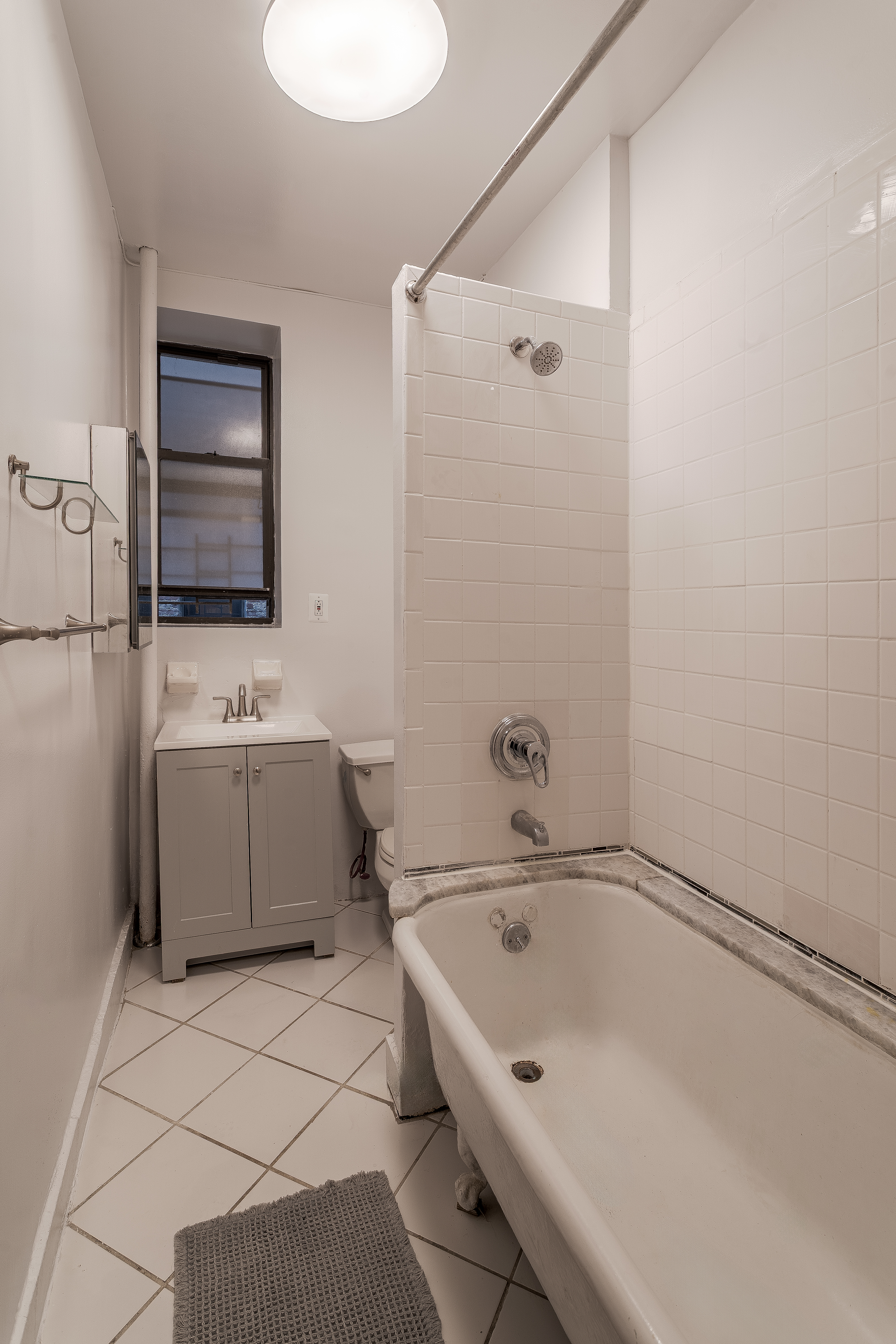 100 West 141st Street, Unit 33 Manhattan, NY 10030 - Photo 8 of 12 a bathroom with a sink a toilet and mirror