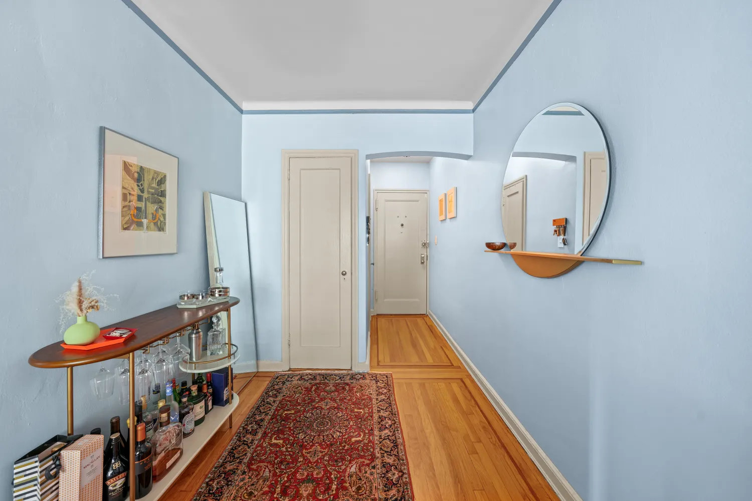 a view of a hallway with wooden floor and staircase