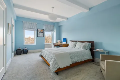 a bedroom with a bed and a couch