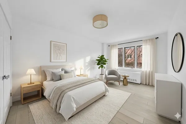 a bedroom with bed and a large window