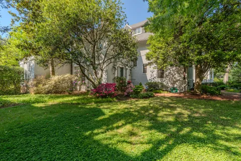 a backyard of a house with table and chairs