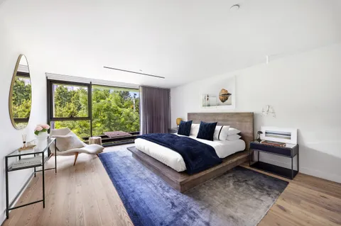 a spacious bedroom with a bed and a large window