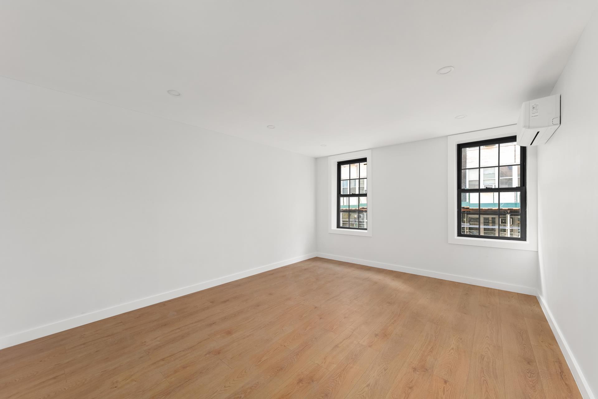 227 East 21st Street, Unit 2F Manhattan, NY 10010 - Photo 2 of 7 an empty room with a window