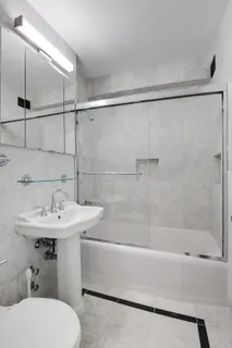 a bathroom with a sink toilet and shower