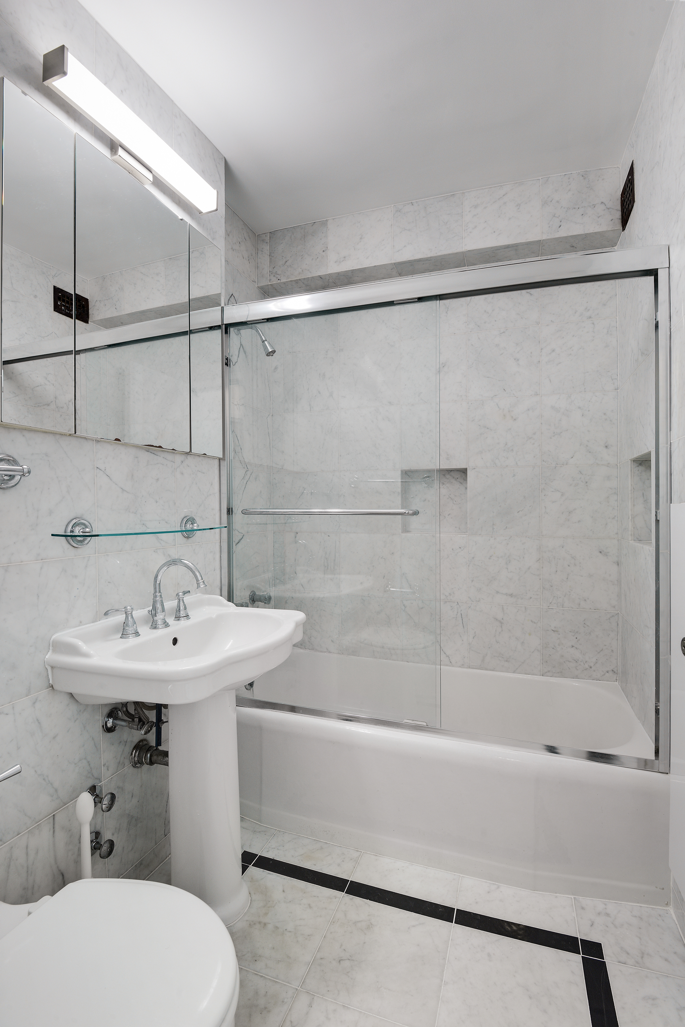 150 East 61st Street, Unit 5C Manhattan, NY 10065 - Photo 14 of 18 a bathroom with a sink toilet and shower