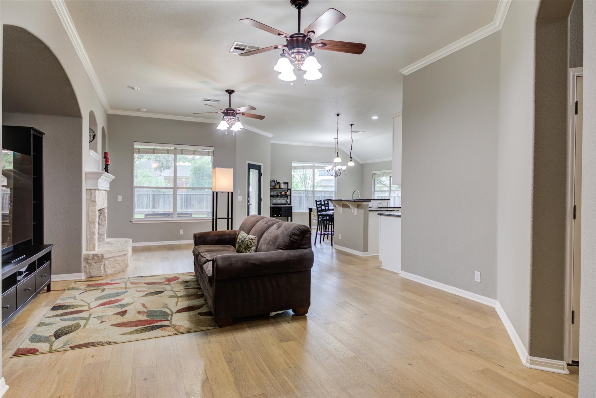 5412 Batak Lane Austin, TX 78749 - Photo 5 of 40 a living room with furniture a chandelier and a flat screen tv