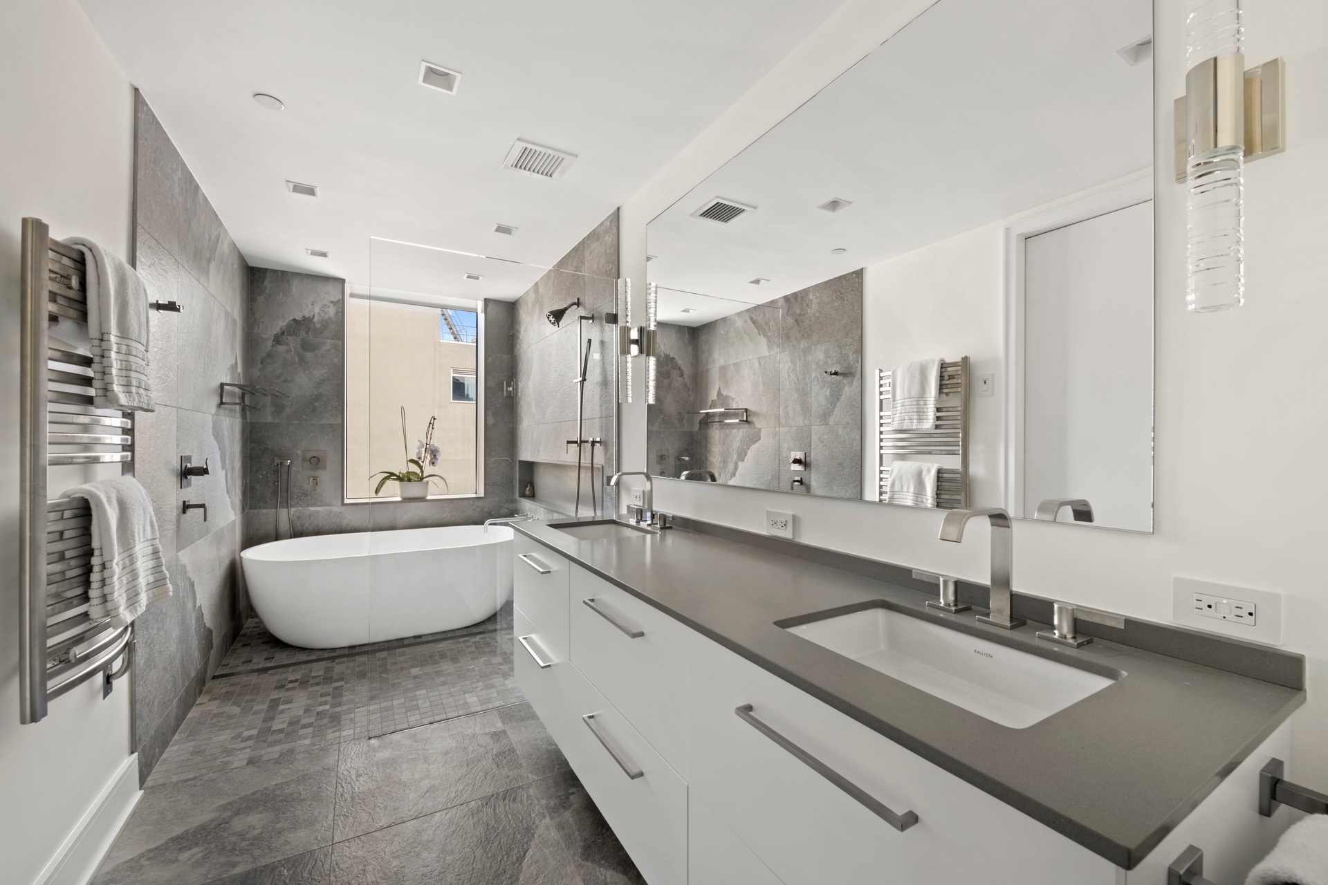 151 West 17th Street, Unit PHF-FURN Manhattan, NY 10011 - Photo 9 of 19 a large white bathroom with a granite countertop tub sink and mirror