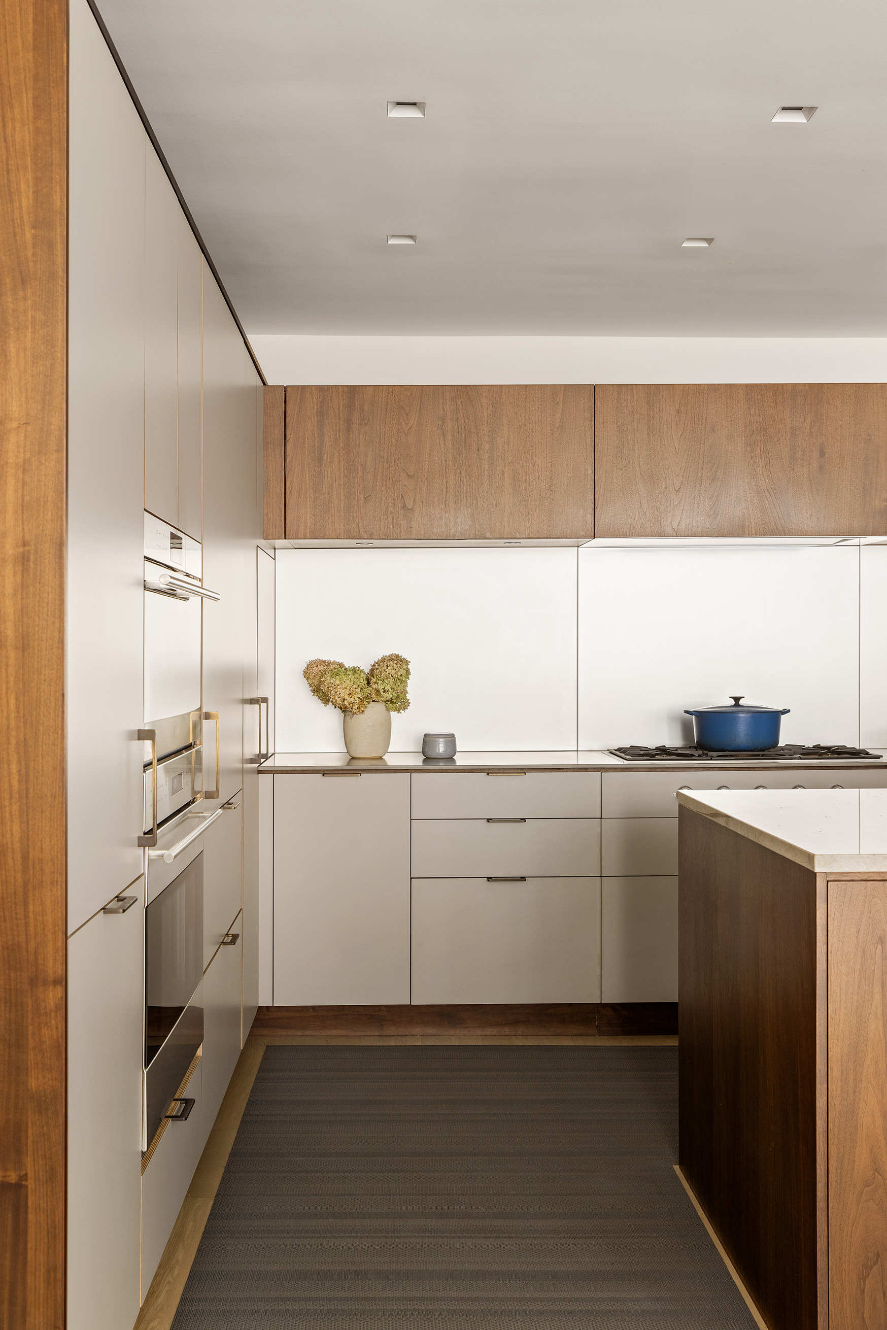 129 West 20th Street, Unit 4B Manhattan, NY 10011 - Photo 4 of 16 a kitchen with white cabinets and white appliances