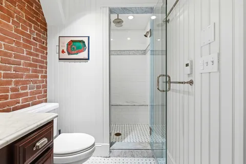 a bathroom with a toilet and a shower