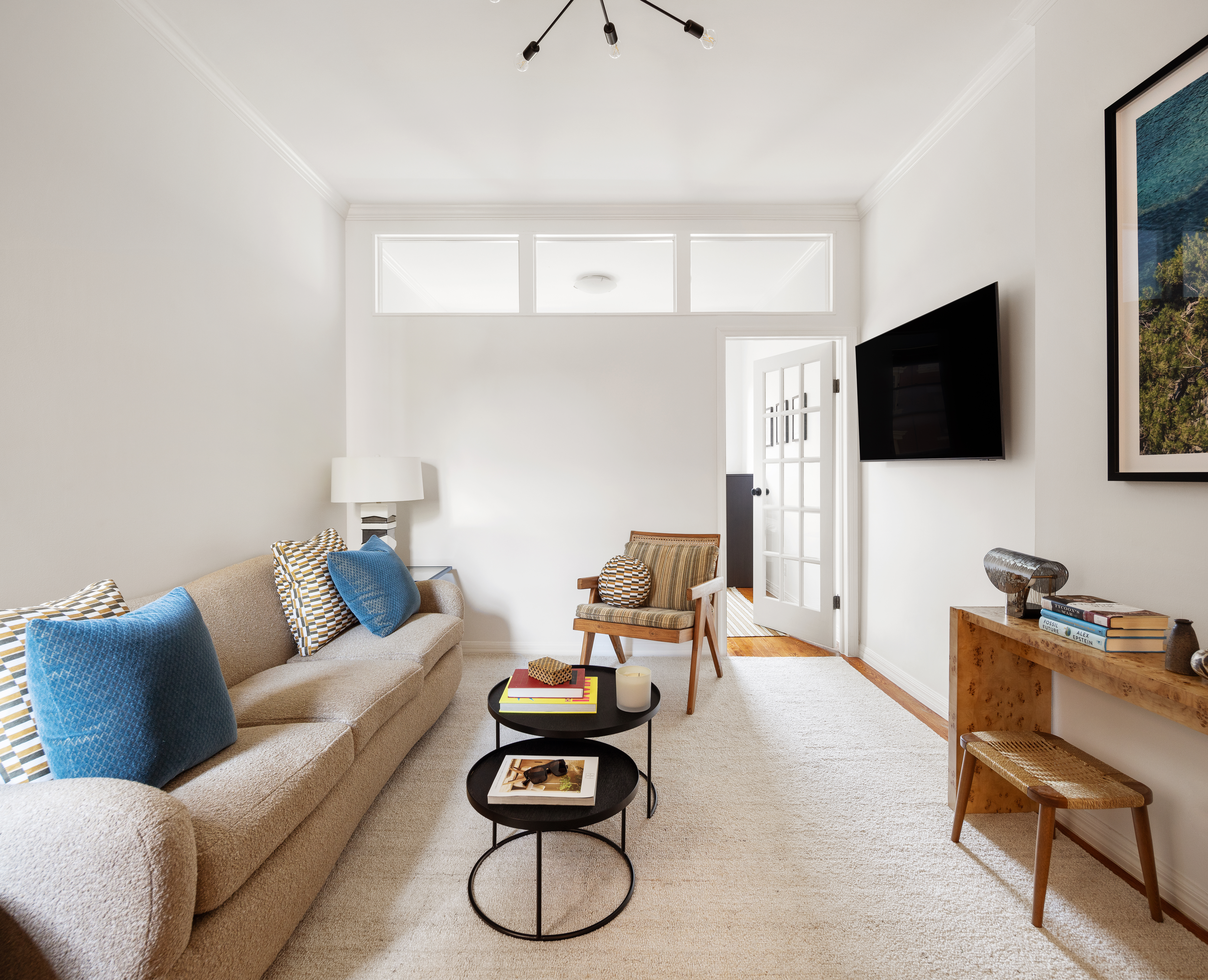 28 Perry Street, Unit 4W Manhattan, NY 10014 - Photo 1 of 7 a living room with furniture and a flat screen tv
