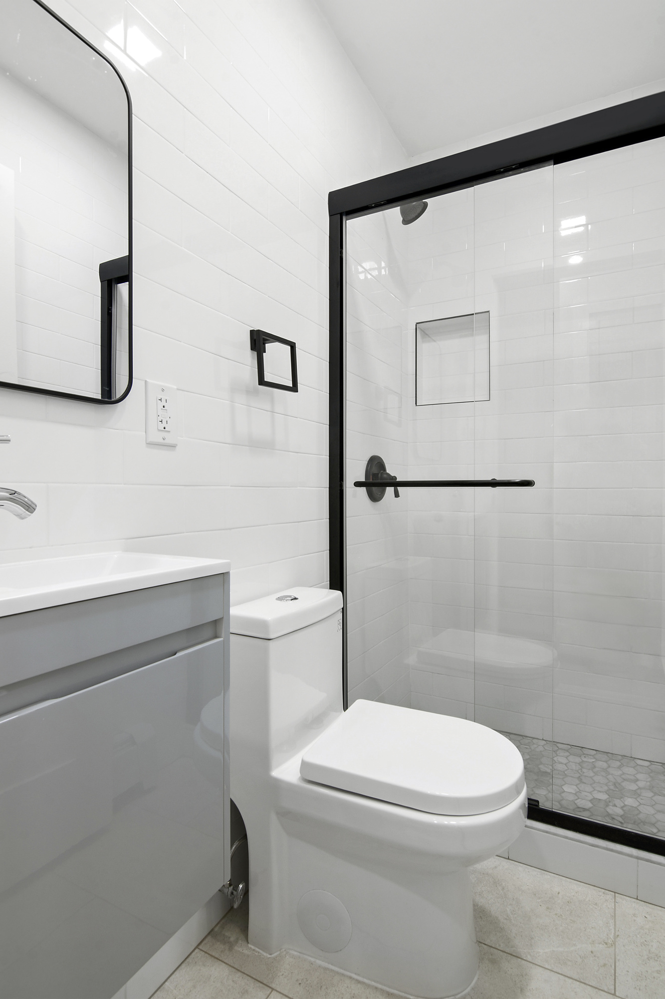 41-05 20th Avenue Queens, NY 11105 - Photo 12 of 20 a bathroom with a toilet a sink and mirror