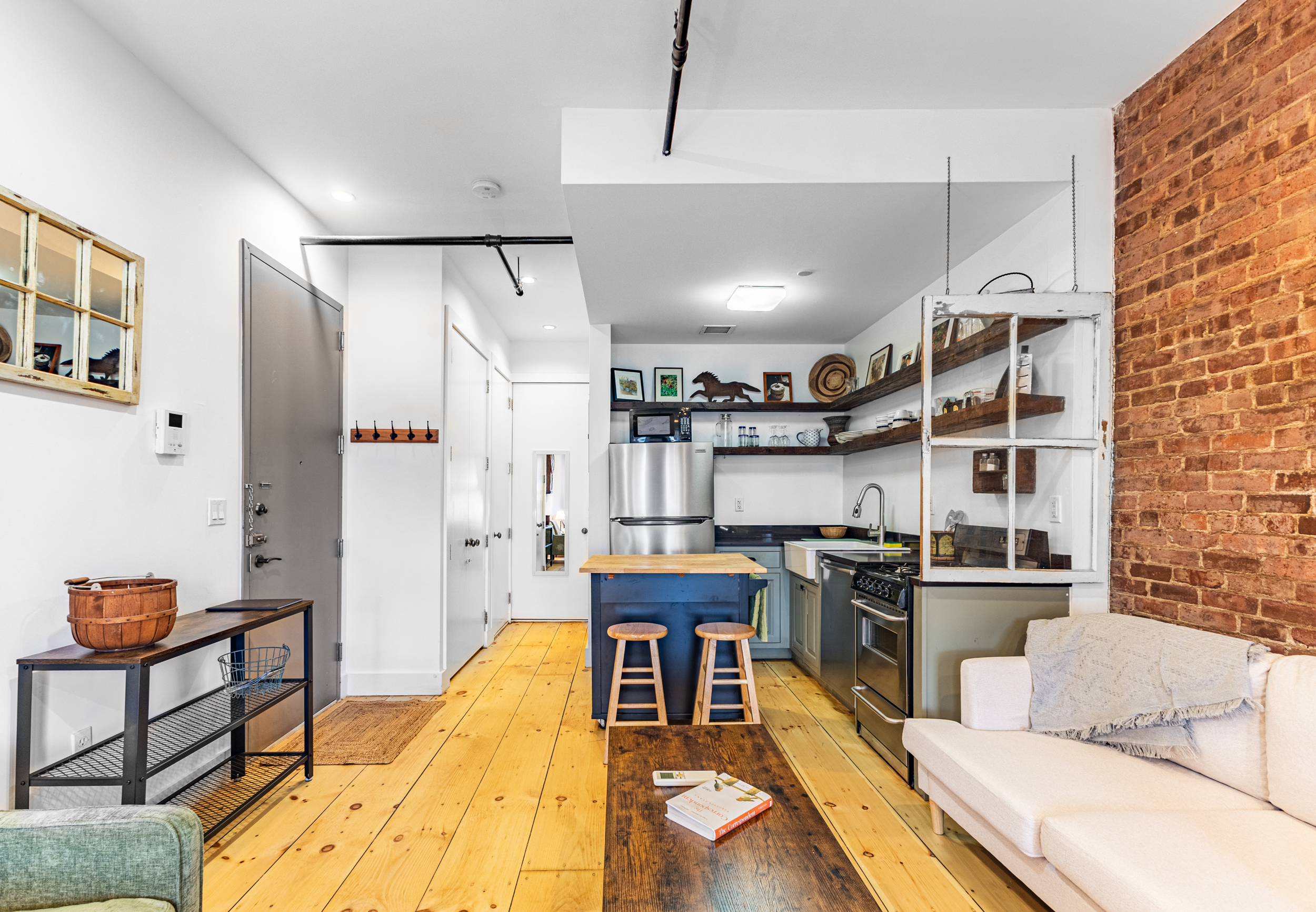 940 Fulton Street, Unit 3B Brooklyn, NY 11238 - Photo 4 of 18 a living room with stainless steel appliances furniture and a kitchen view