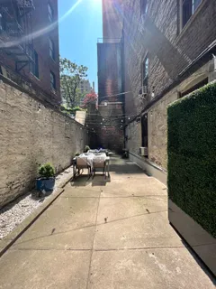 a building outdoor space with patio furniture and potted plants