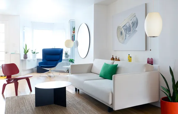 a living room with furniture and a mirror