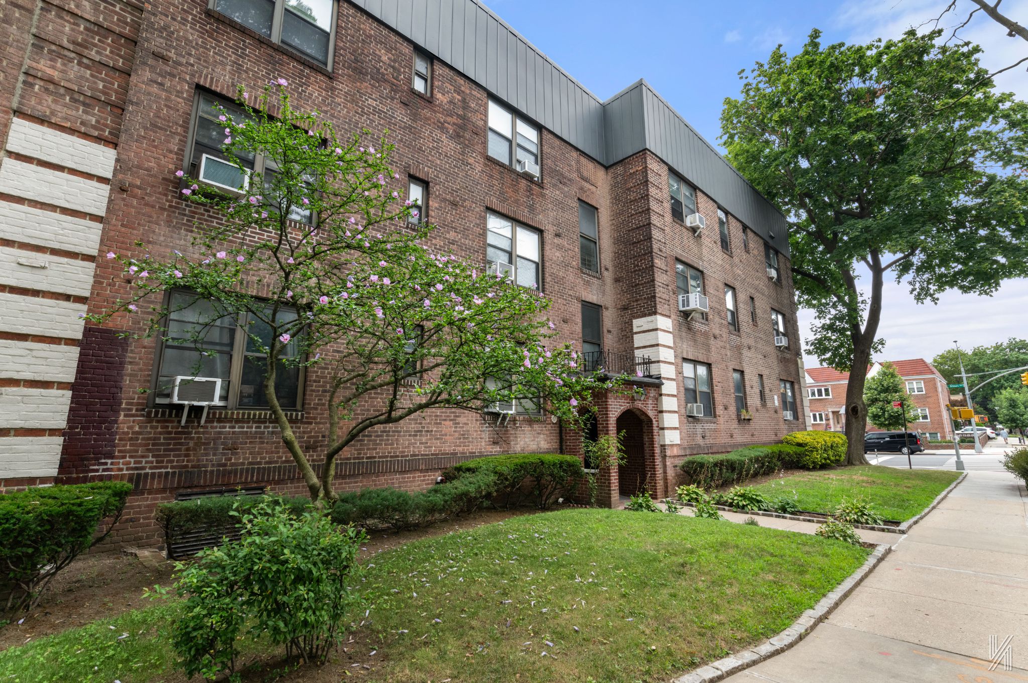 22-08 76th Street, Unit D2 Queens, NY 11370 - Photo 19 of 20 a view of a building with a yard