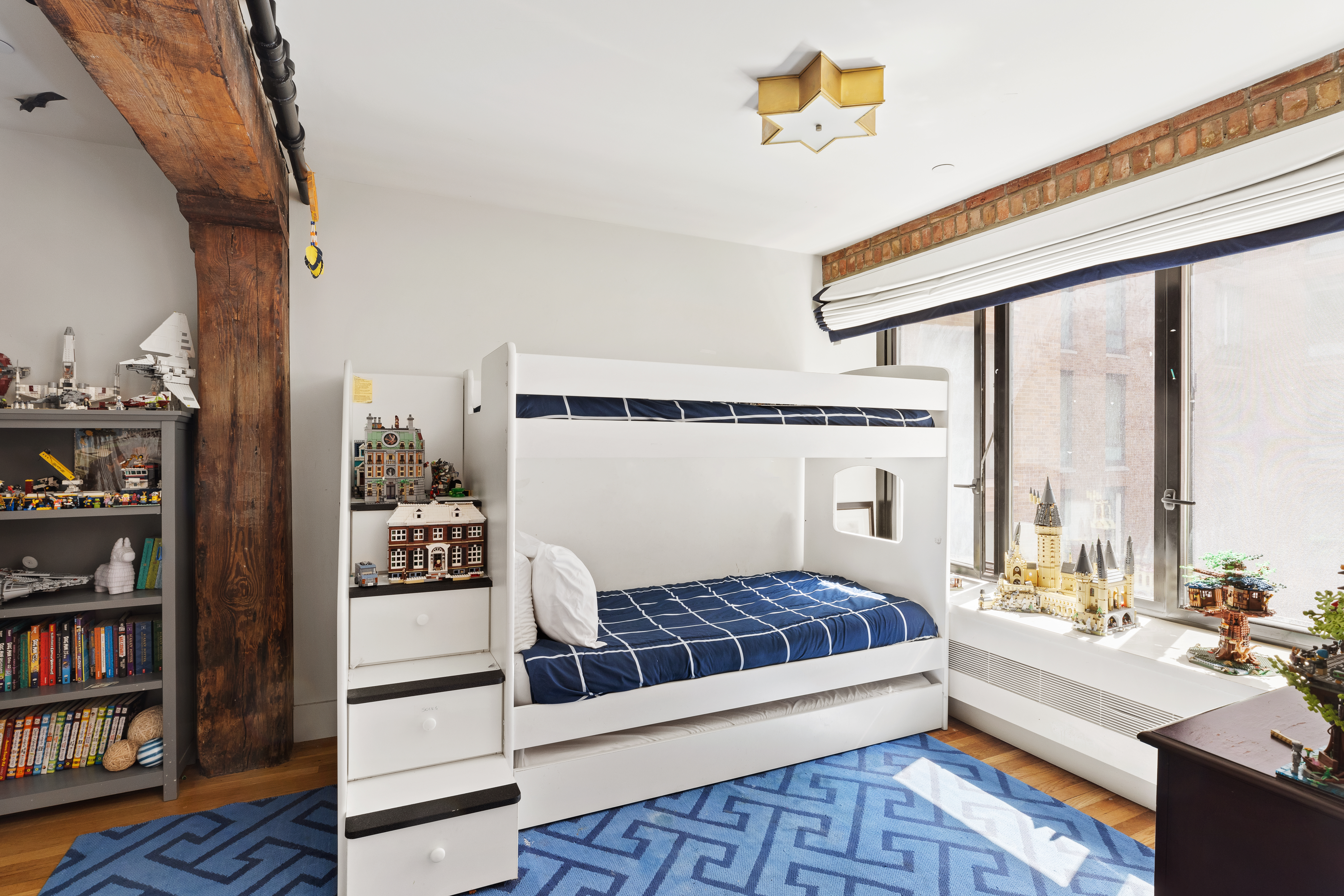 466 Washington Street, Unit 3W Manhattan, NY 10013 - Photo 9 of 14 a spacious bedroom with a bed and a book shelf