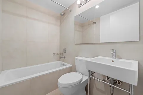 a bathroom with a sink a toilet and a bathtub