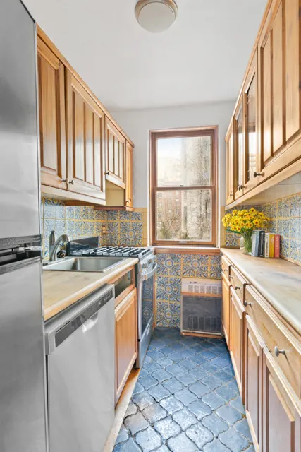 a kitchen with granite countertop a sink stove top oven and cabinets