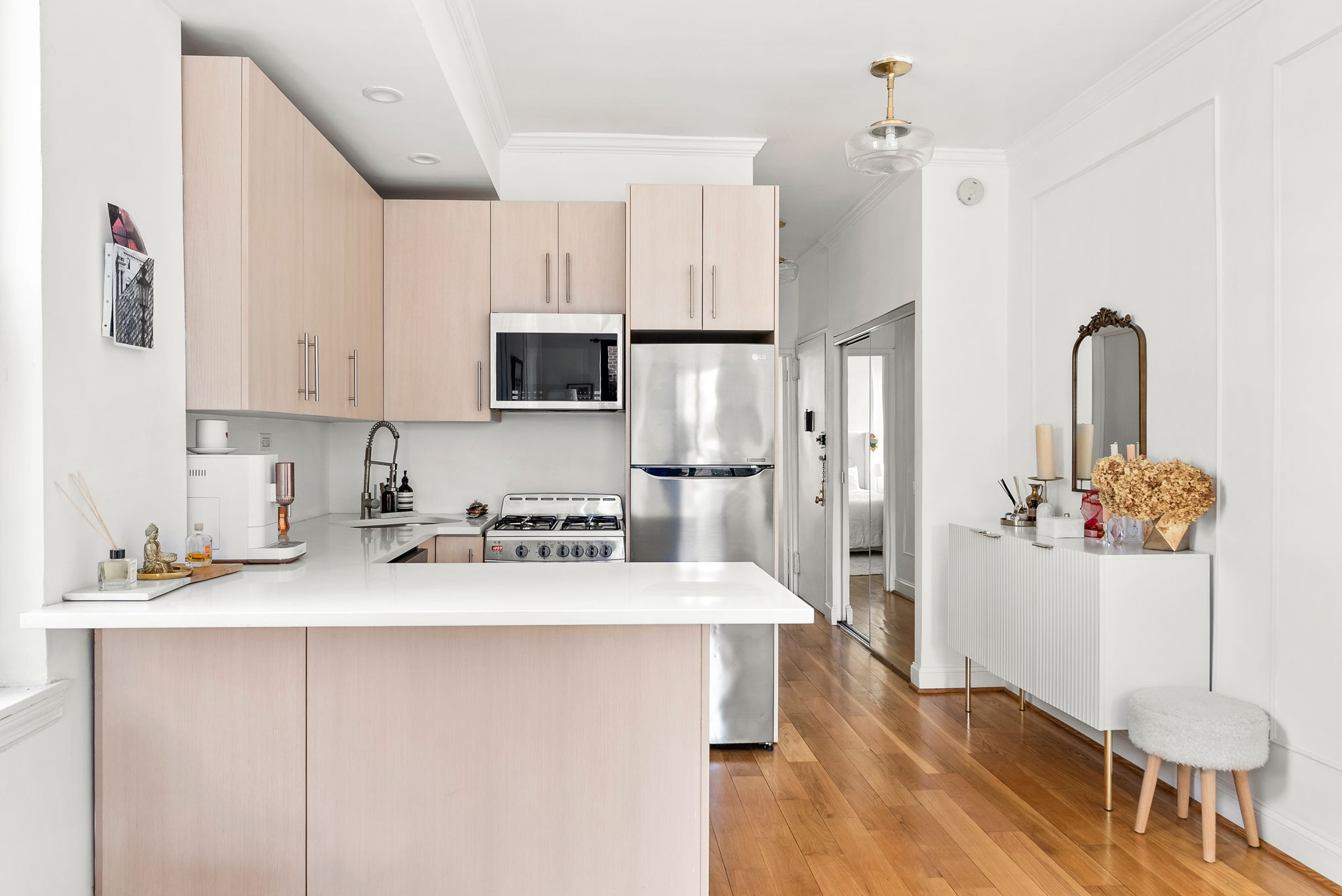 512 East 83rd Street, Unit D4 Manhattan, NY 10028 - Photo 9 of 21 a kitchen with stainless steel appliances granite countertop a refrigerator sink and white cabinets