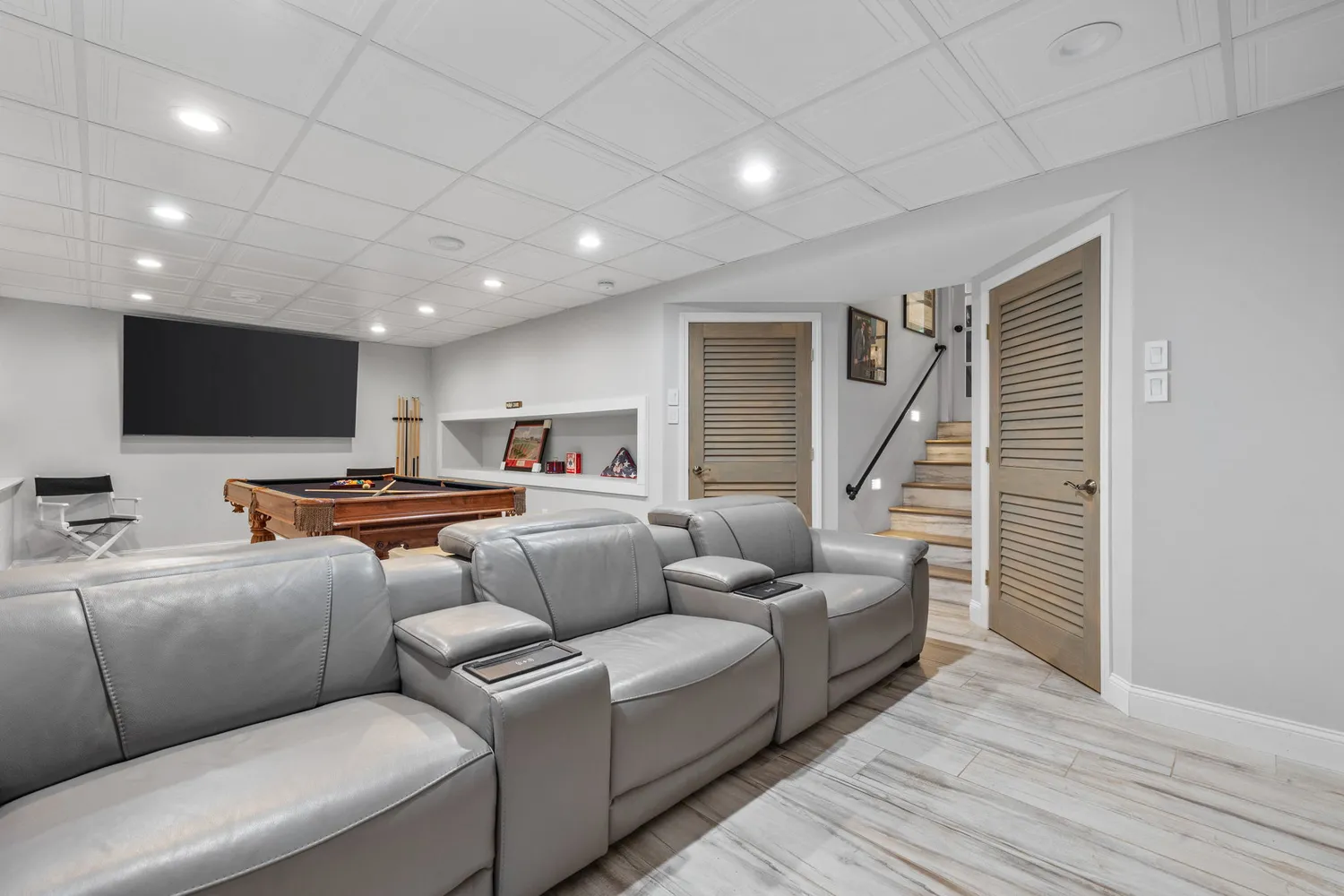 a room with furniture pool table flat screen tv and a table