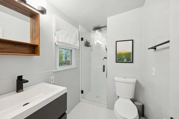 a bathroom with a toilet a sink and mirror