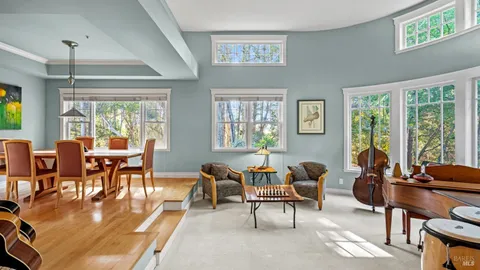 a living room with furniture and a floor to ceiling window