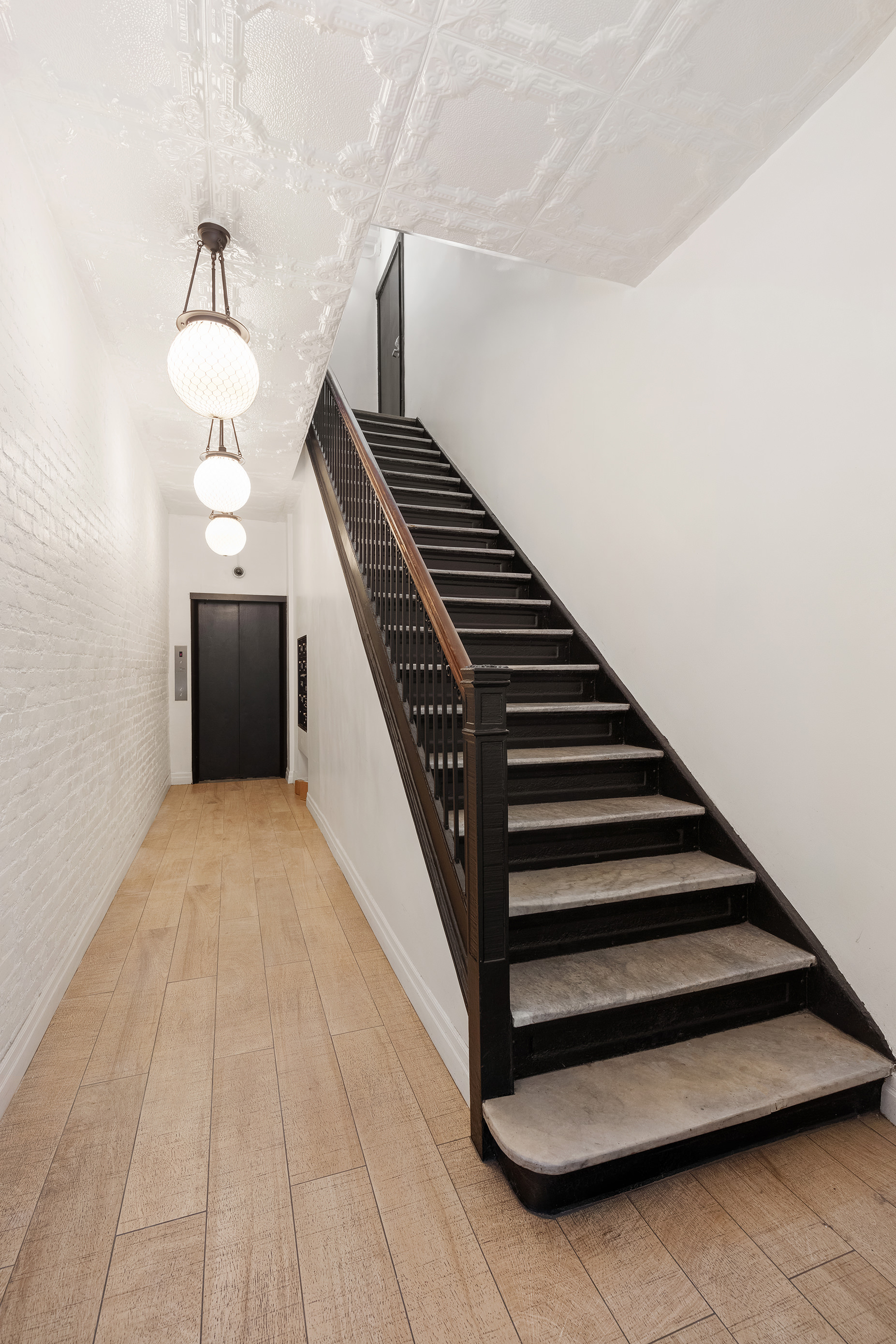 143 West 27th Street, Unit 2R Manhattan, NY 10001 - Photo 11 of 13 a view of entryway and hall with wooden floor