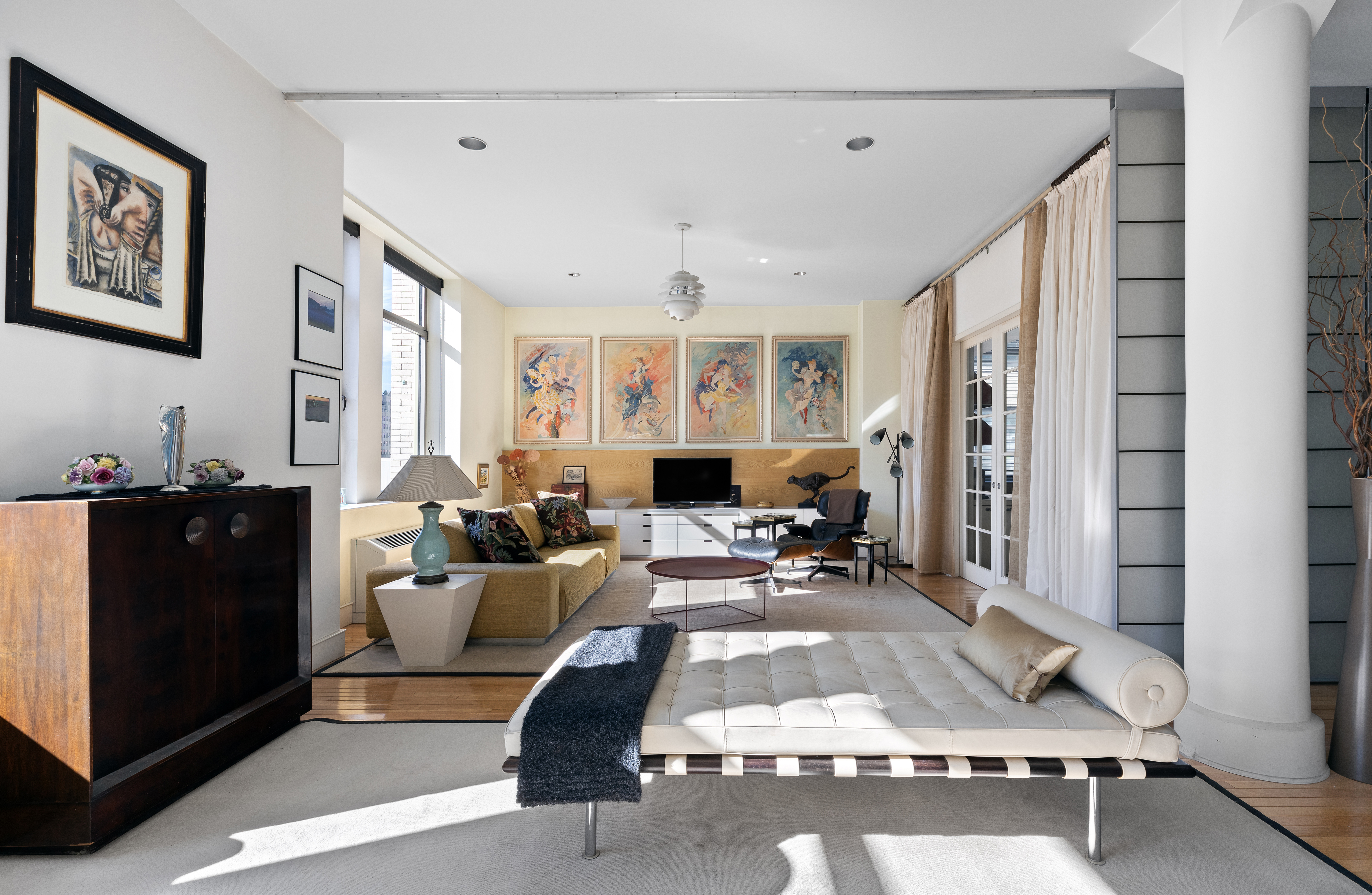 252 7th Avenue, Unit 9X Manhattan, NY 10001 - Photo 1 of 26 a living room with furniture a large window and gym equipment