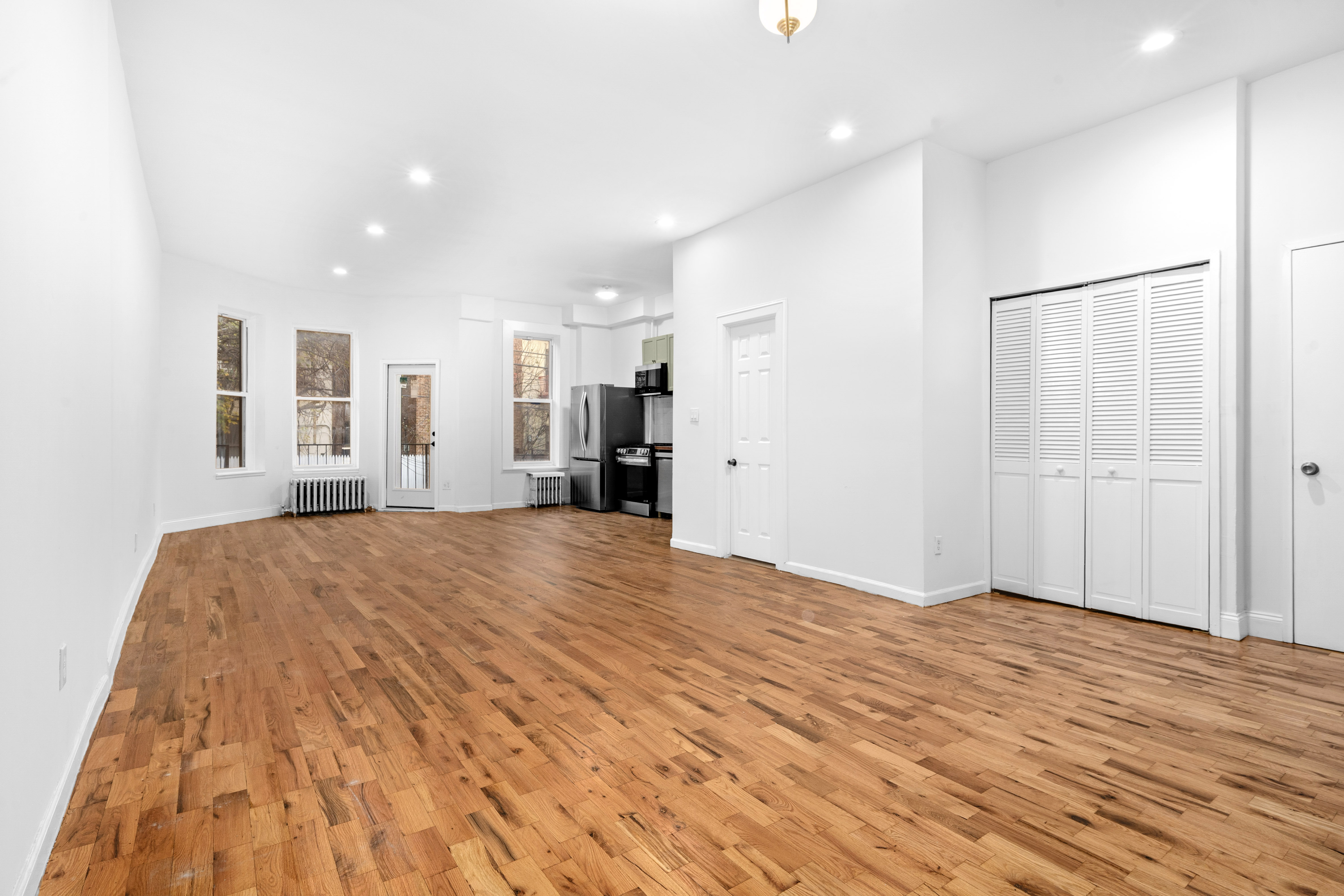 339 East 29th Street Brooklyn, NY 11226 - Photo 13 of 21 a view of empty room with kitchen and windows
