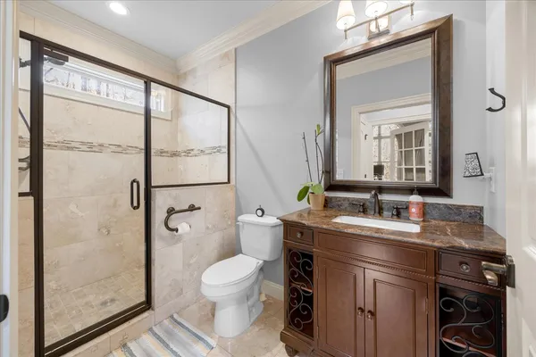 a kitchen with stainless steel appliances kitchen island granite countertop a table chairs refrigerator and sink