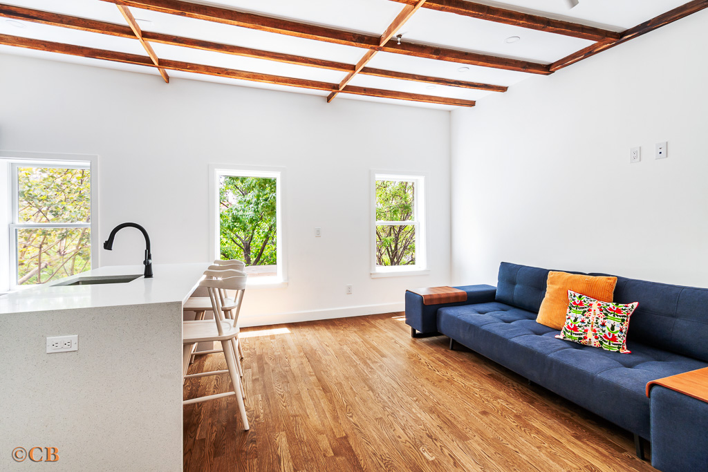 a living room with furniture and a wooden floor