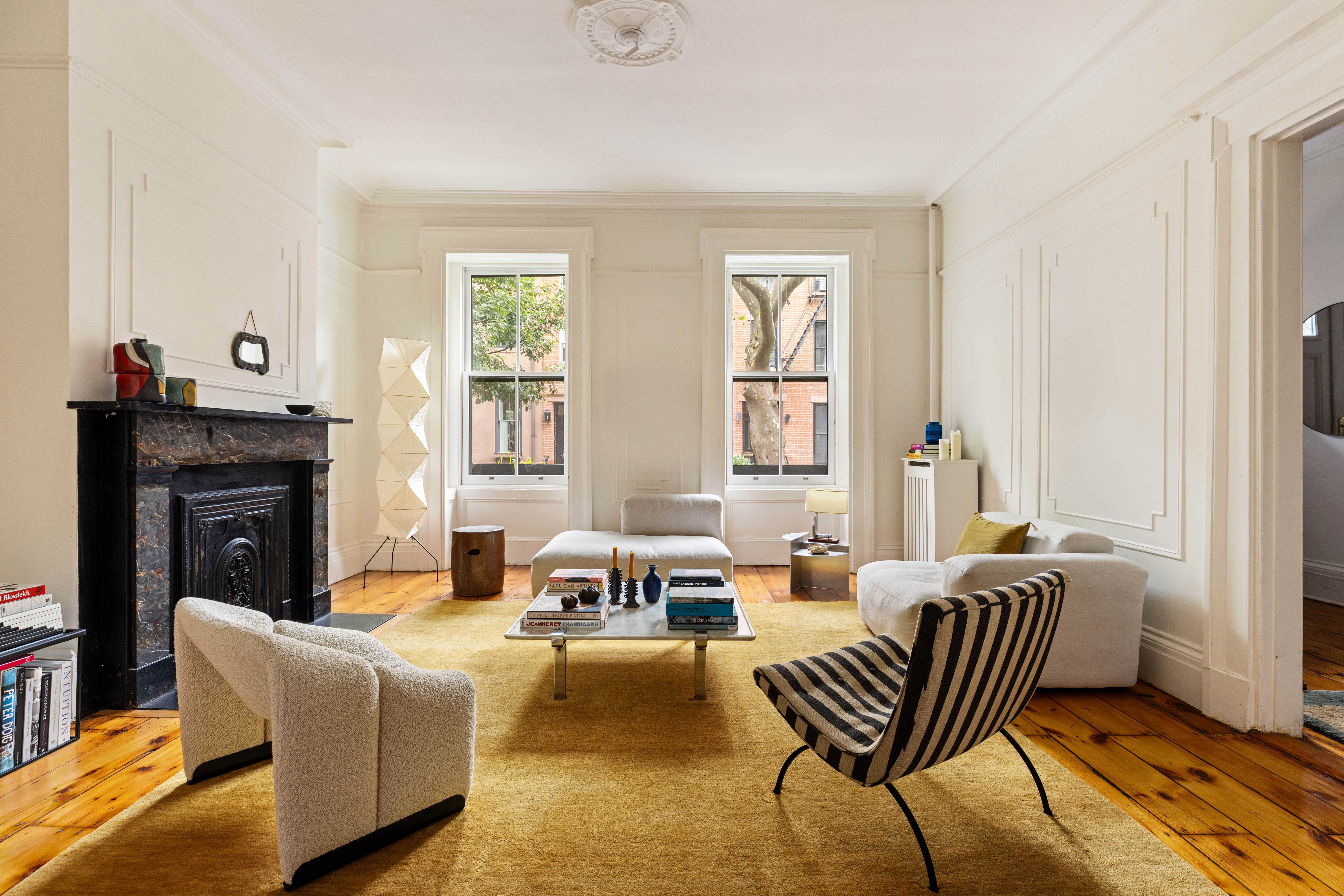188 Warren Street, Unit TRIPLEX Brooklyn, NY 11201 - Photo 1 of 15 a living room with furniture and a fireplace