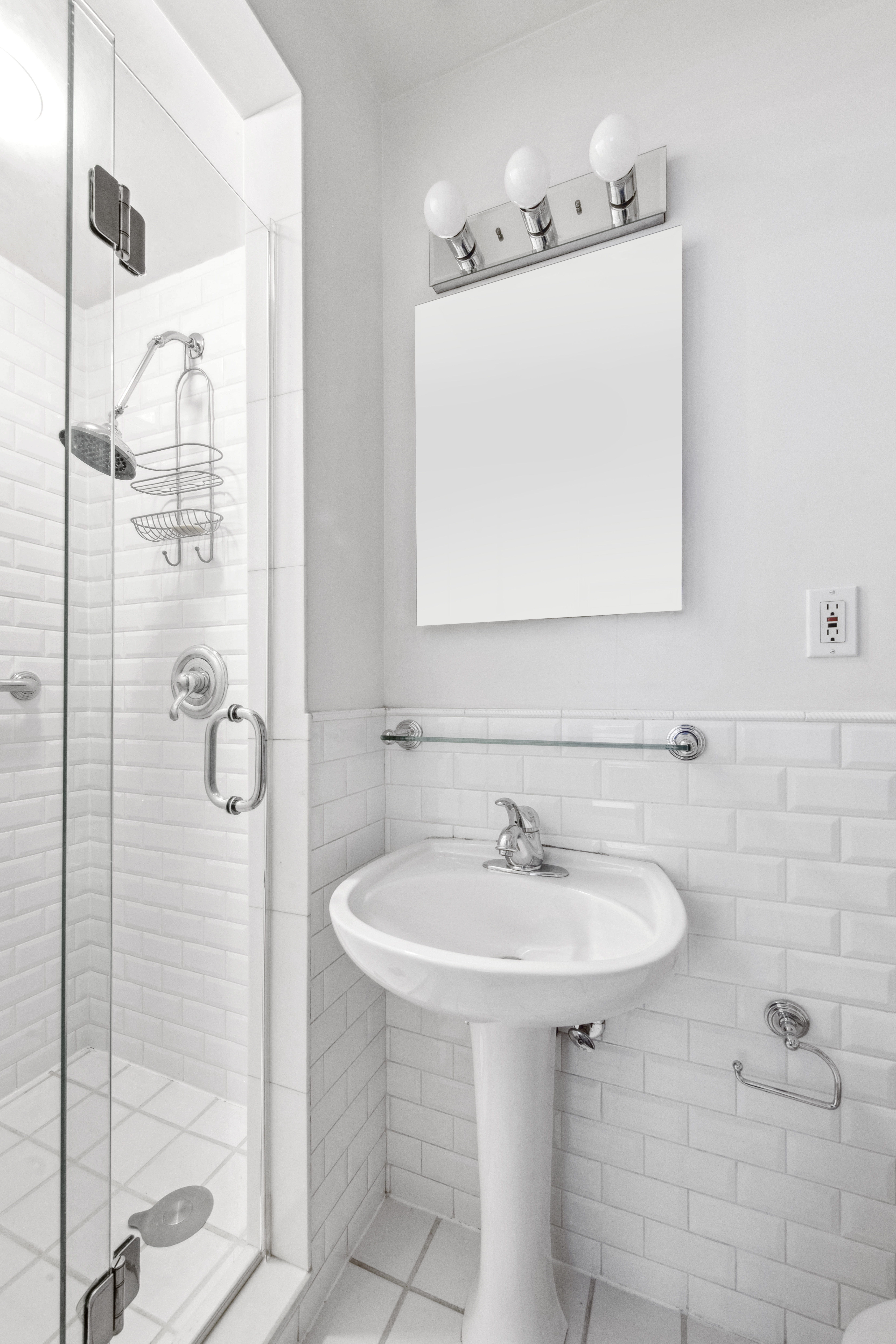 45 West 54th Street, Unit 3CD Manhattan, NY 10019 - Photo 11 of 14 a bathroom with a sink a mirror and shower