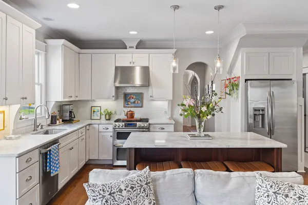 a kitchen with a refrigerator and a sink