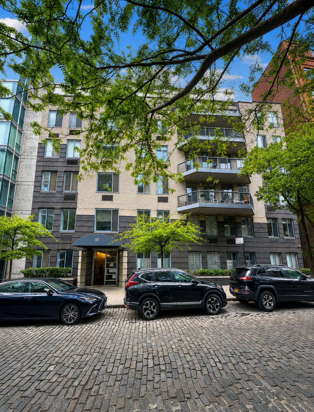 167 Perry Street, Unit 1D/2D Manhattan, NY 10014 - Photo 10 of 13 a view of a building with street