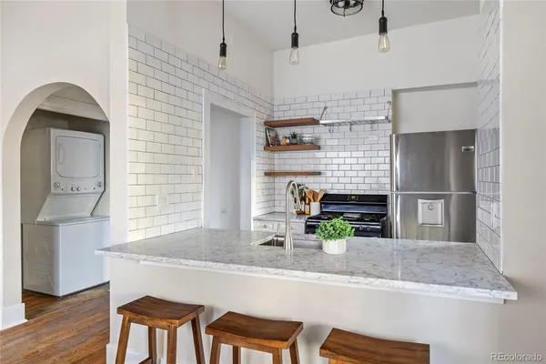 a kitchen with cabinets and wooden floor