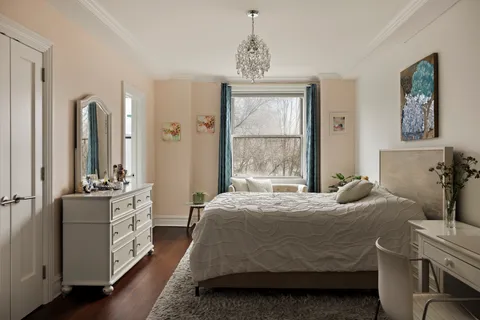 a bedroom with a bed and a chandelier