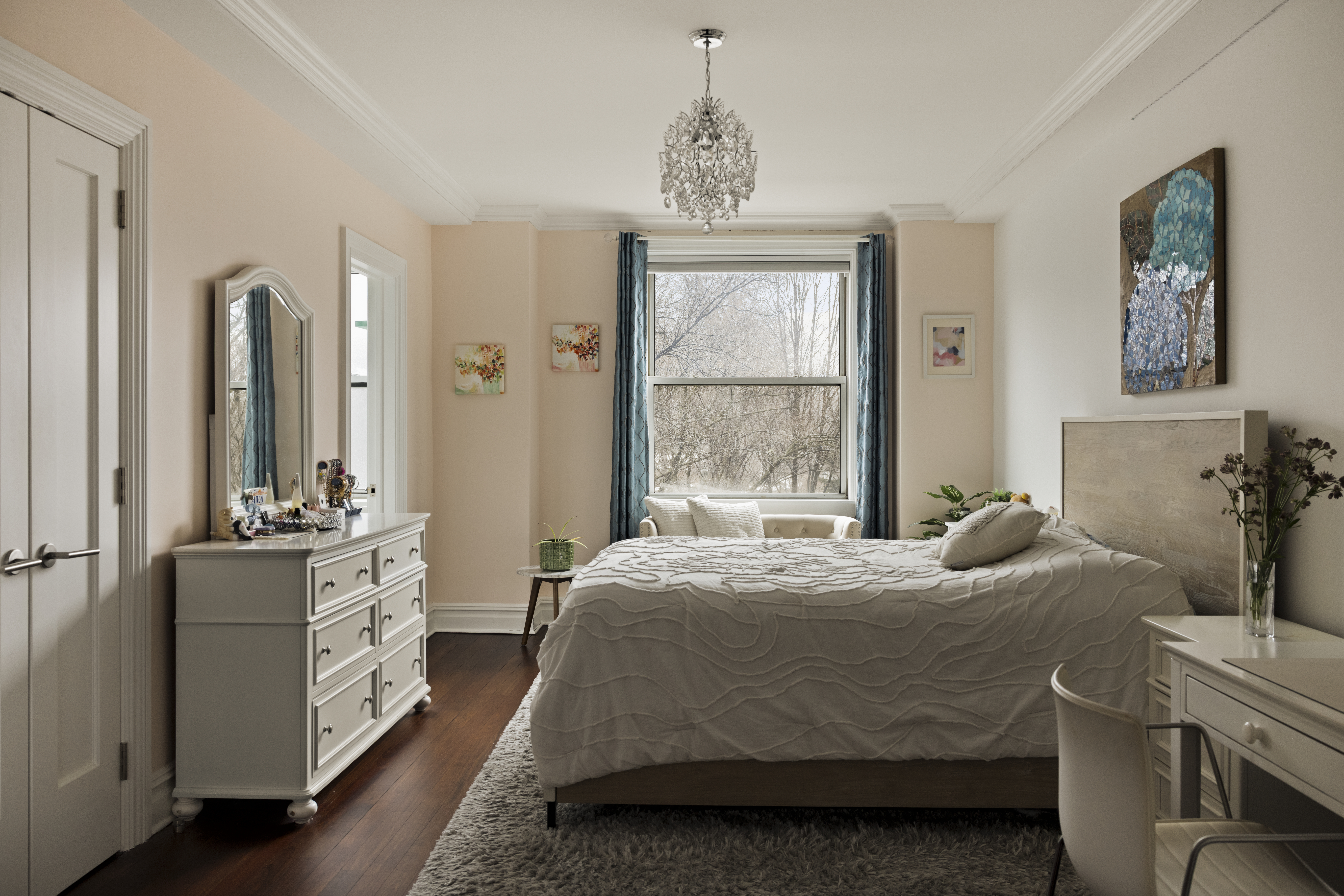 1158 5th Avenue, Unit 4A Manhattan, NY 10128 - Photo 9 of 23 a bedroom with a bed and a chandelier