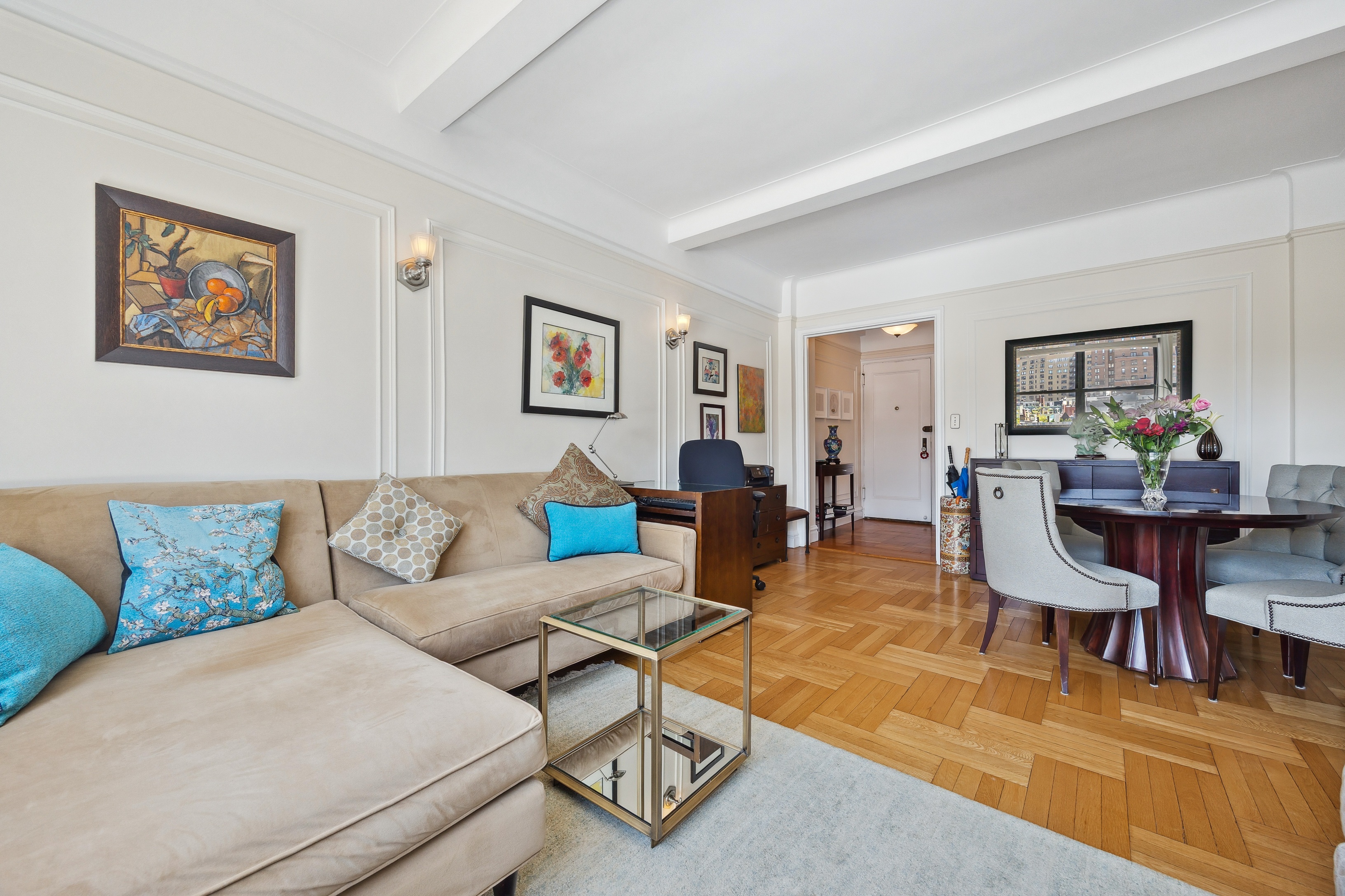 40 West 77th Street, Unit 8C Manhattan, NY 10024 - Photo 3 of 21 a living room with furniture dining table and a painting on the wall