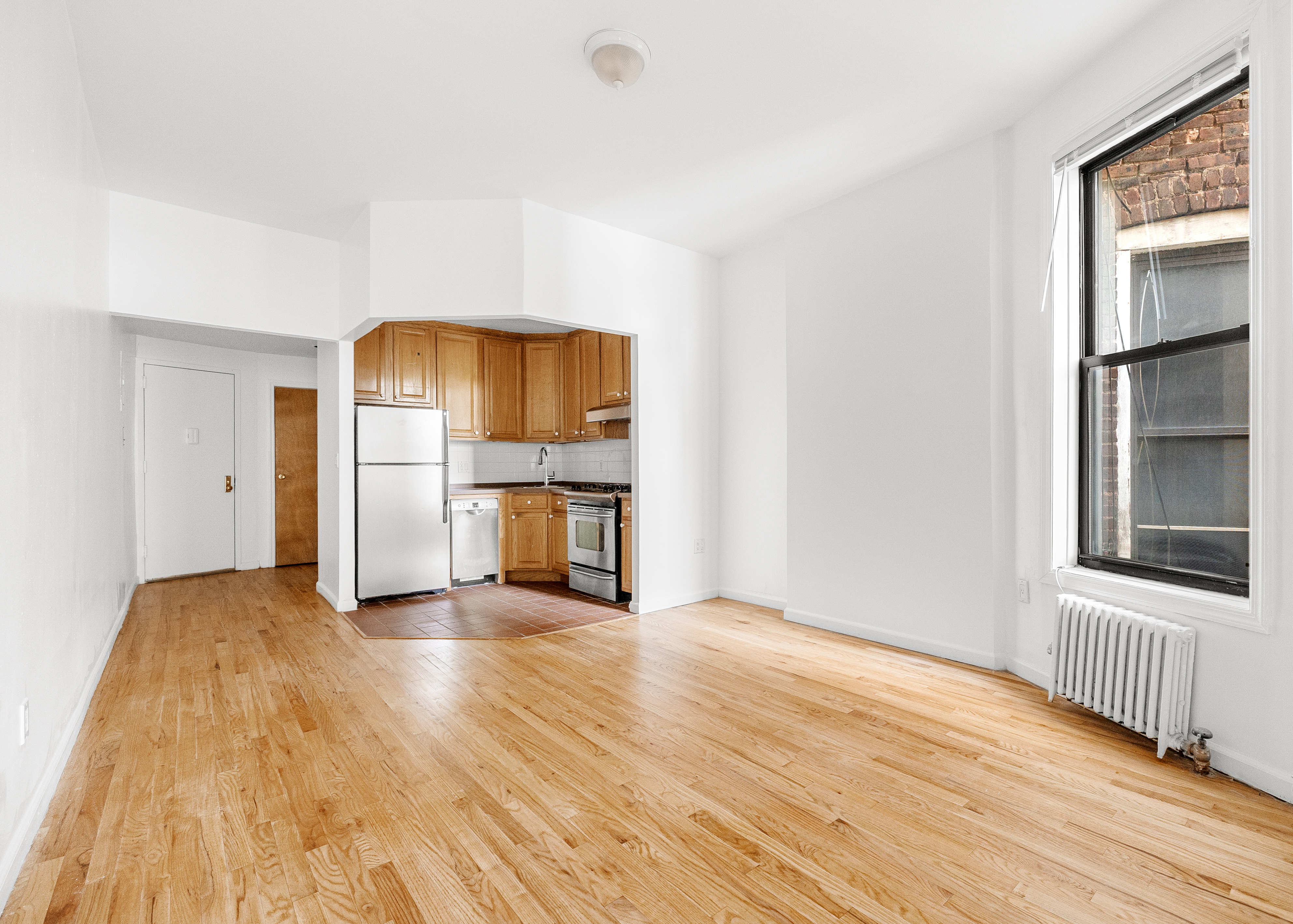 325 3rd Street, Unit 2A Brooklyn, NY 11215 - Photo 9 of 13 a view of a kitchen with wooden floor and refrigerator