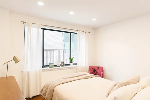 61 Lexington Avenue, Unit 4H Manhattan, NY 10010 - Photo 3 of 6 a bedroom with a bed and a large window