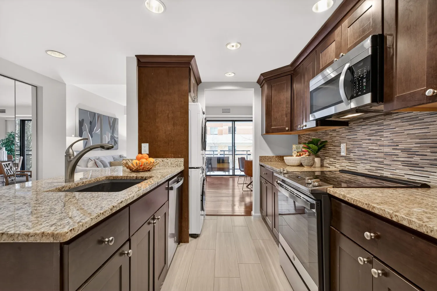 a kitchen with stainless steel appliances granite countertop a sink and stove