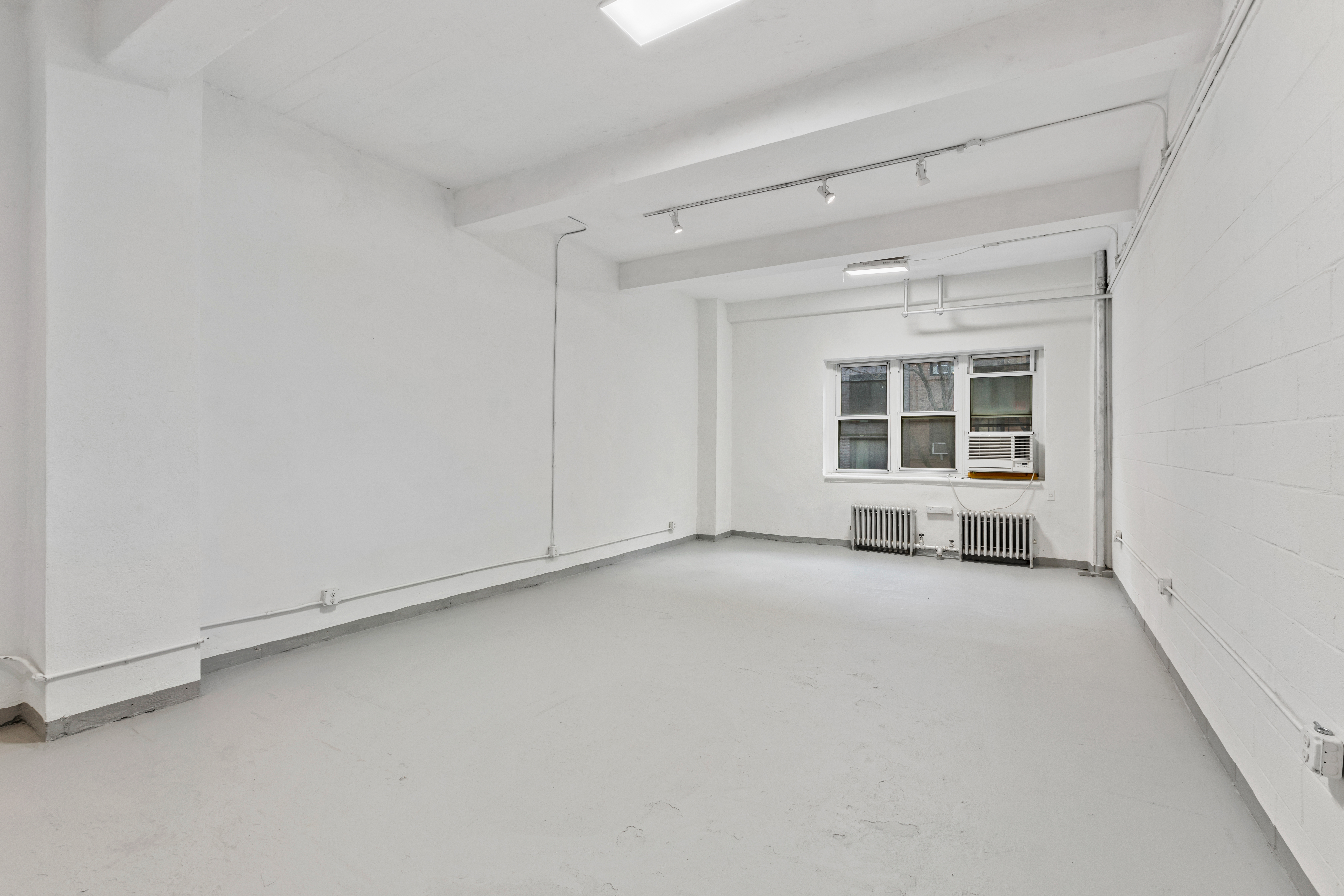 315 East 91st Street, Unit 2E Manhattan, NY 10128 - Photo 7 of 7 an empty room with windows