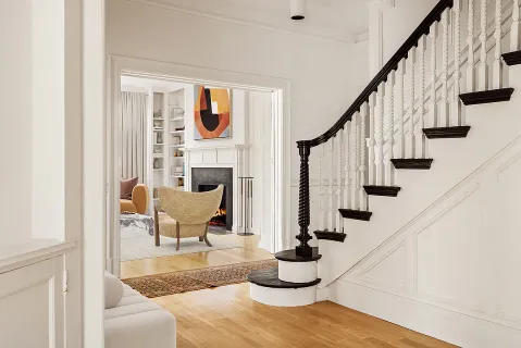 a view of entryway and hall with wooden floor