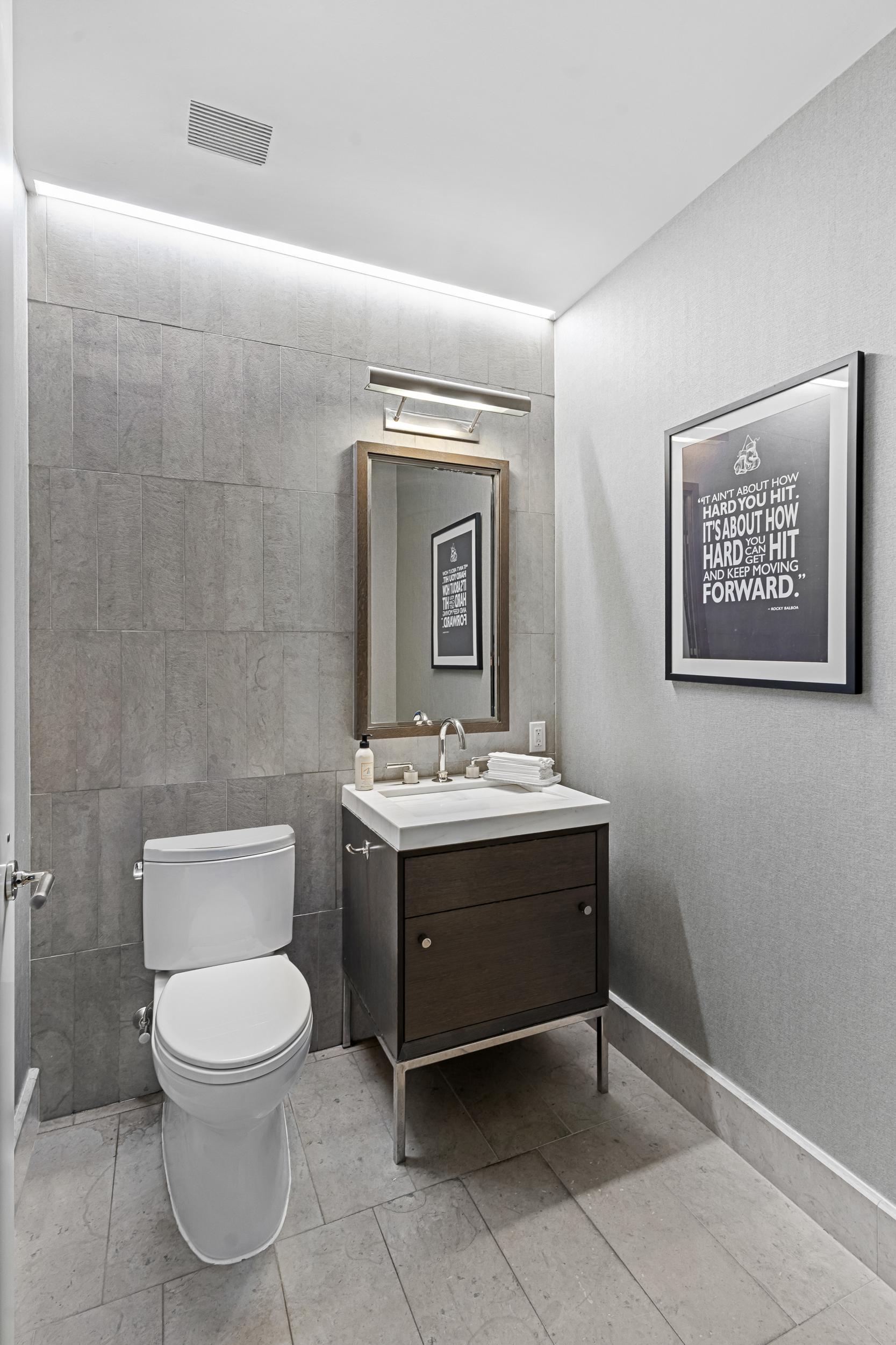 301 East 50th Street, Unit 5A Manhattan, NY 10022 - Photo 11 of 19 a bathroom with a toilet sink and mirror