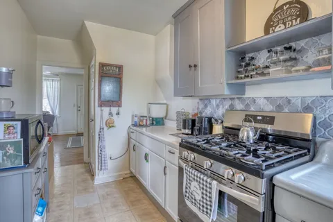 a kitchen with stainless steel appliances granite countertop a stove and a sink