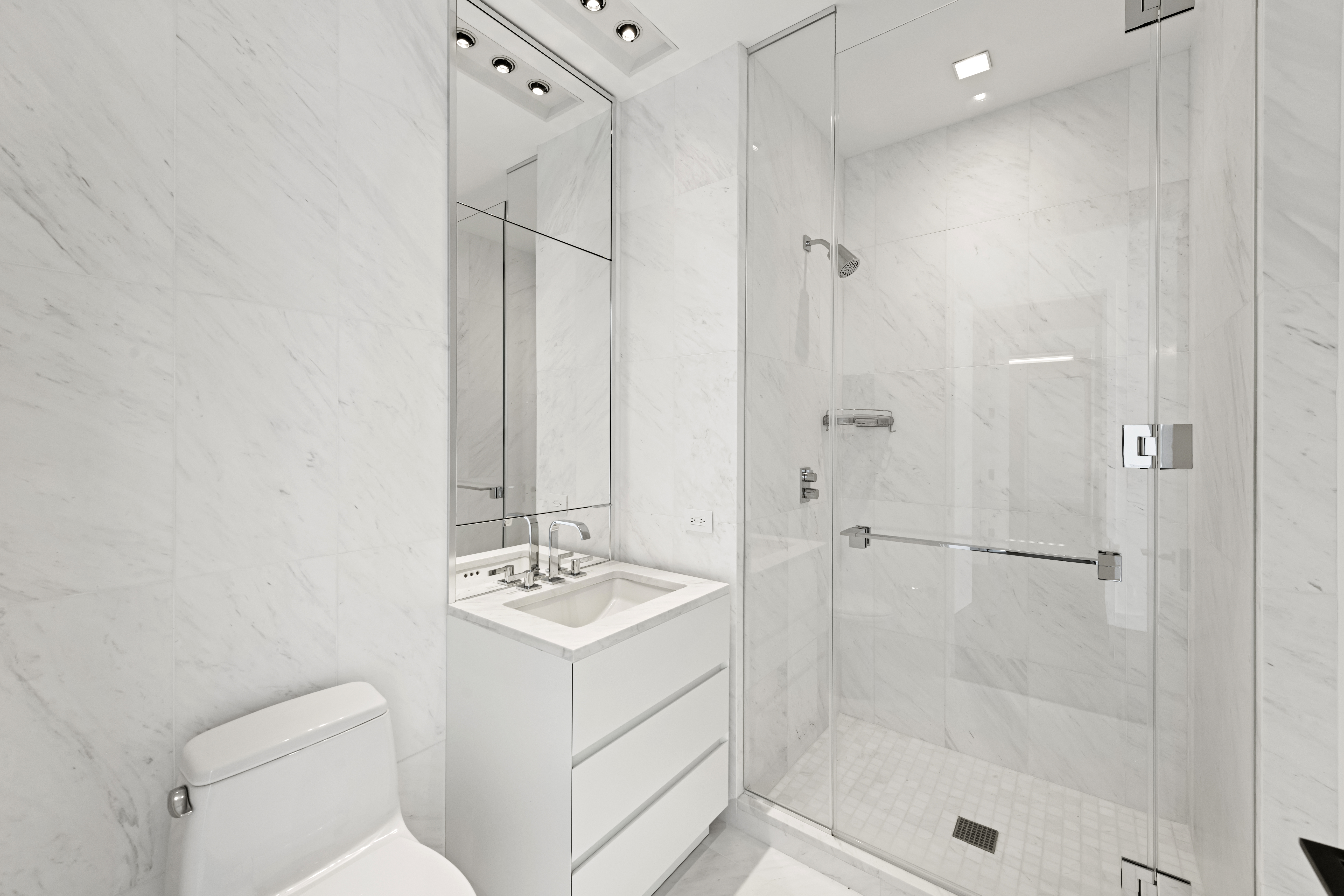 111 Murray Street, Unit 51EAST Manhattan, NY 10007 - Photo 19 of 42 a bathroom with a shower a sink and mirror