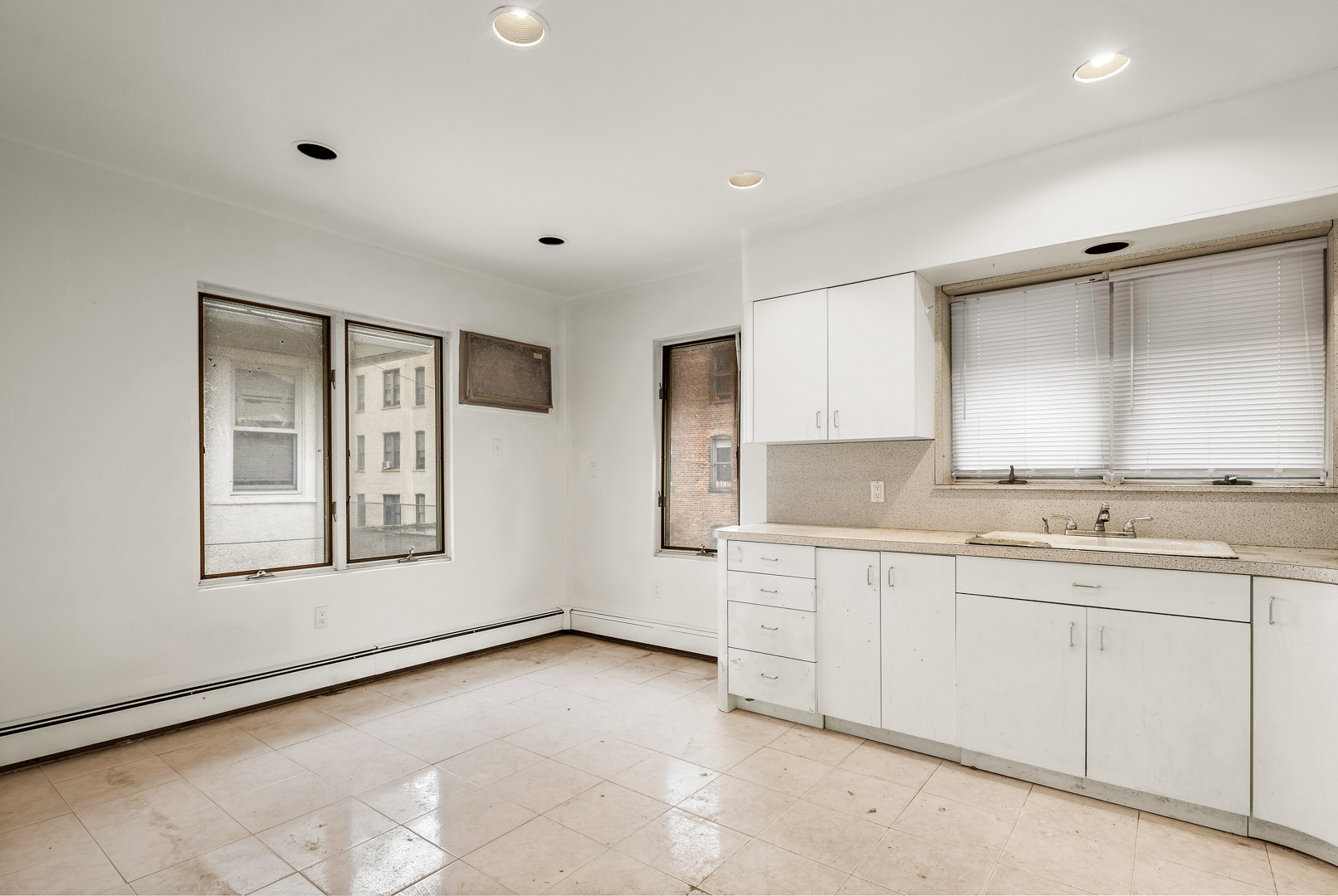 558 84th Street Brooklyn, NY 11209 - Photo 14 of 25 a large white room with double vanity sink and window