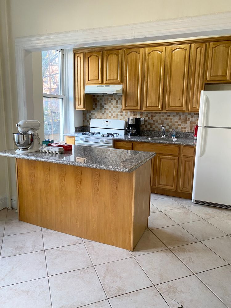 23 Saint Marks Avenue, Unit 3 Brooklyn, NY 11217 - Photo 4 of 10 a kitchen with stainless steel appliances granite countertop a sink counter space cabinets and a large window