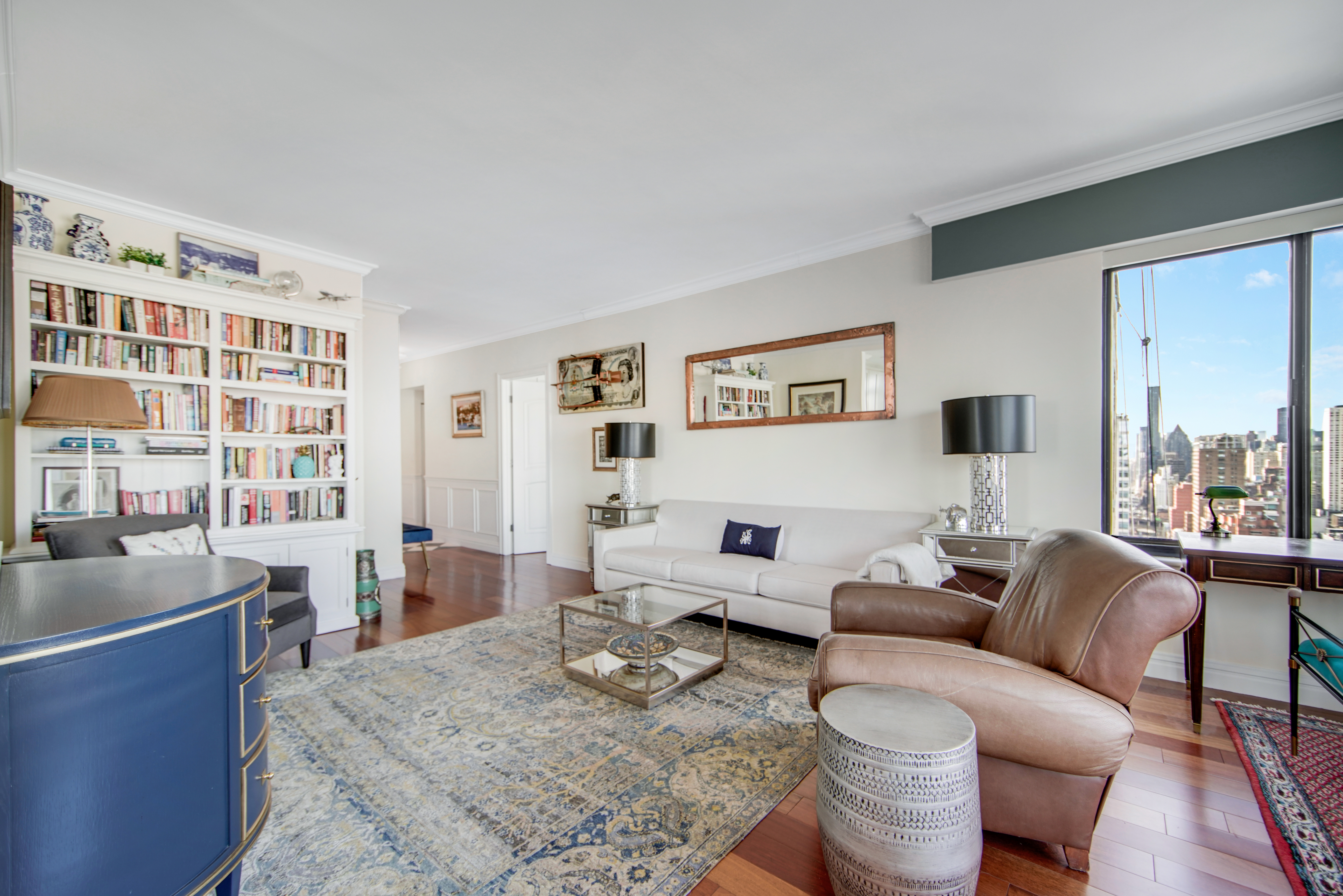 400 East 70th Street, Unit 3301 Manhattan, NY 10021 - Photo 5 of 20 a living room with furniture or couch and a bookshelf